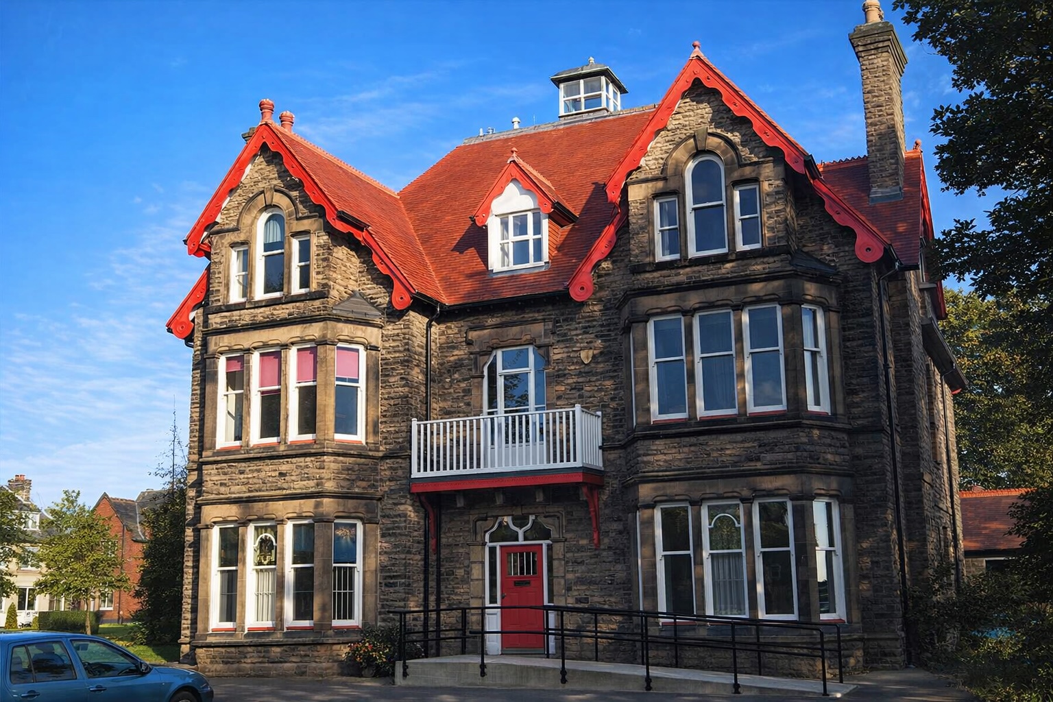 The Grove, a substantial Victorian stone building with distinctive red roof and bay windows, located on Station Road, Royston
